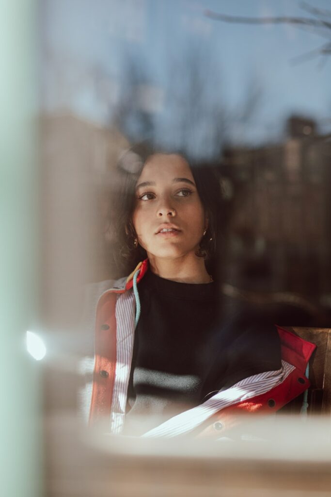 Young woman looking out a window thoughtfully